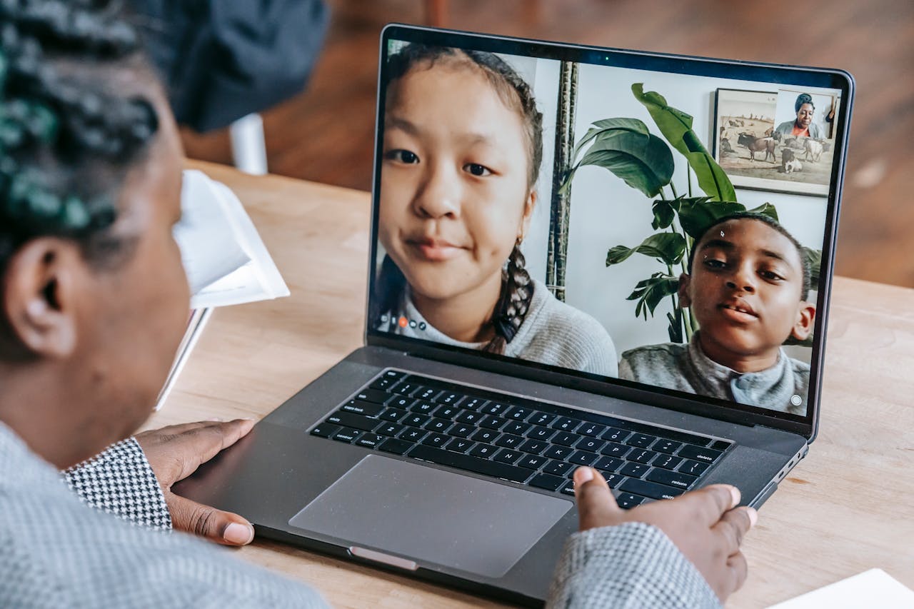 digital A teacher holding an online class with diverse students through a laptop during a distance learning session.